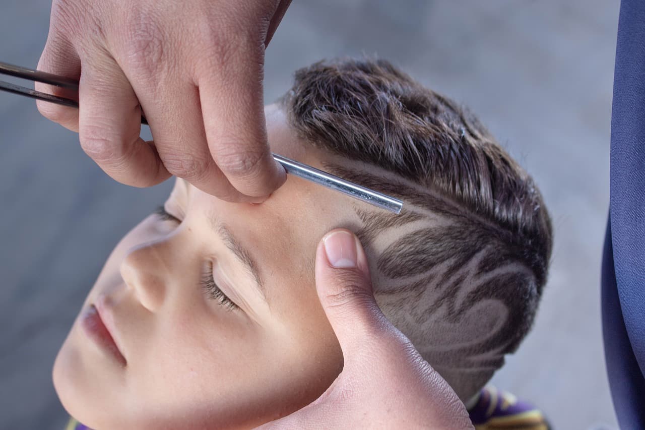 Boy having a design shaved into a fresh short cut